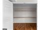 Spacious walk-in closet with built-in shelving and hardwood floors at 550 Davis Rd, Fayetteville, GA 30215