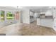 Open dining area with large windows, chandelier and kitchen access at 550 Davis Rd, Fayetteville, GA 30215