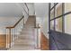 Spacious foyer featuring a grand staircase and hardwood floors, providing a warm and inviting entrance at 550 Davis Rd, Fayetteville, GA 30215