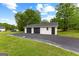 Detached three-car garage with black doors and a large driveway for ample parking at 550 Davis Rd, Fayetteville, GA 30215