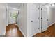 Inviting hallway with hardwood floors and white trim, leading to various rooms in the home at 550 Davis Rd, Fayetteville, GA 30215
