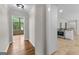 Hallway with hardwood flooring leading to a kitchen and other rooms at 550 Davis Rd, Fayetteville, GA 30215