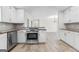 Open kitchen with modern appliances and an adjacent living area at 550 Davis Rd, Fayetteville, GA 30215