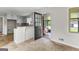 Bright, well-equipped kitchen featuring white cabinets and door leading to a screened in porch at 550 Davis Rd, Fayetteville, GA 30215