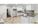 Bright kitchen featuring white cabinets, granite countertops and tile flooring at 550 Davis Rd, Fayetteville, GA 30215