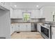 Stylish kitchen featuring white cabinets and stainless steel appliances at 550 Davis Rd, Fayetteville, GA 30215