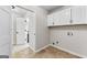 Laundry room with white cabinets and access to a doorway at 550 Davis Rd, Fayetteville, GA 30215