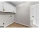 Laundry room features white cabinets and access to a doorway at 550 Davis Rd, Fayetteville, GA 30215