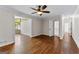 Bright living room showcasing hardwood floors, neutral paint, and open access to other living spaces at 550 Davis Rd, Fayetteville, GA 30215