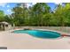 Inviting in-ground pool with a stone hot tub, a table with umbrella, and privacy fencing at 550 Davis Rd, Fayetteville, GA 30215