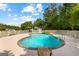 In-ground pool with a stone hot tub, surrounded by a white fence, perfect for entertaining at 550 Davis Rd, Fayetteville, GA 30215