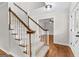 Elegant staircase with carpeted steps, wood railings, and white balusters leading to the upper level at 550 Davis Rd, Fayetteville, GA 30215