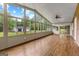 Spacious sunroom with wood floors, multiple windows offering natural light and backyard views at 550 Davis Rd, Fayetteville, GA 30215