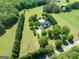 Aerial view of a large property with a home, in-ground pool, and mature trees at 1040 Rock Creek Rd, Social Circle, GA 30025
