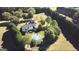 Aerial view showcasing home with pool, guesthouse, expansive grounds, and mature trees offering privacy at 1040 Rock Creek Rd, Social Circle, GA 30025