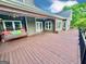 View of a large, stained back deck with a porch swing and an exterior view of the home at 1040 Rock Creek Rd, Social Circle, GA 30025