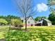 Lush backyard with well-maintained lawn and house featuring upper deck and oversized garage at 1040 Rock Creek Rd, Social Circle, GA 30025