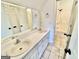 Well-lit bathroom features a dual sink vanity and tiled floors, offering both style and functionality at 1040 Rock Creek Rd, Social Circle, GA 30025