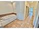 Bathroom features soaking tub with tile surround and tile floors at 1040 Rock Creek Rd, Social Circle, GA 30025