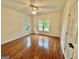 Bedroom with hardwood floors, ceiling fan and two windows overlooking the yard at 1040 Rock Creek Rd, Social Circle, GA 30025