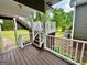 Outdoor deck with stairs leading to green lawn; ideal for relaxing and enjoying the natural surroundings at 1040 Rock Creek Rd, Social Circle, GA 30025