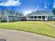 Sprawling home with green lawn, mature trees and long porch at 1040 Rock Creek Rd, Social Circle, GA 30025