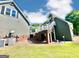 View of the side and back of the house, showcasing the multi-level design and outdoor features at 1040 Rock Creek Rd, Social Circle, GA 30025
