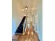 Bright foyer with black stairs, wood railing and wood floors at 1040 Rock Creek Rd, Social Circle, GA 30025