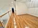 Bright, open hallway with hardwood flooring, connecting the home's living spaces at 1040 Rock Creek Rd, Social Circle, GA 30025