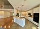 Open kitchen with tile floors, white cabinets, stainless appliances and view to living room at 1040 Rock Creek Rd, Social Circle, GA 30025