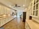 Open kitchen with white cabinets, stainless appliances, and tiled floor at 1040 Rock Creek Rd, Social Circle, GA 30025