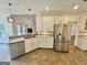 Open kitchen with stainless appliances, tiled floor and breakfast bar area at 1040 Rock Creek Rd, Social Circle, GA 30025