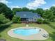 Beautiful in-ground pool with diving board and lounge chairs, surrounded by a landscaped yard at 1040 Rock Creek Rd, Social Circle, GA 30025