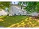 A spacious backyard featuring a well-manicured lawn and mature trees at 402 Sherrels Frd, Peachtree City, GA 30269