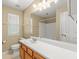 Bathroom with vanity, large mirror, tile floor, toilet, tub and shower combo at 402 Sherrels Frd, Peachtree City, GA 30269