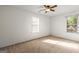 Bright bedroom with neutral walls, two windows with blinds, and ceiling fan at 402 Sherrels Frd, Peachtree City, GA 30269