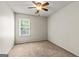 Neutral bedroom with carpet, window with blinds, ceiling fan and light fixture at 402 Sherrels Frd, Peachtree City, GA 30269