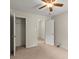 Bedroom with neutral carpet, ceiling fan, closet, and access to another room at 402 Sherrels Frd, Peachtree City, GA 30269
