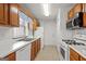 Bright kitchen featuring ample countertop space, white appliances, and wood cabinetry at 402 Sherrels Frd, Peachtree City, GA 30269