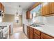 Bright kitchen featuring white countertops and appliances, with wood cabinets and backsplash at 402 Sherrels Frd, Peachtree City, GA 30269