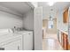 Functional laundry room with washer, dryer, and shelving for storage at 402 Sherrels Frd, Peachtree City, GA 30269