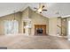 Bright, open living room with a brick fireplace and view into the kitchen area and stairs at 402 Sherrels Frd, Peachtree City, GA 30269