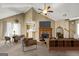 Bright living room featuring a brick fireplace, vaulted ceilings with fan, and contemporary furnishings at 402 Sherrels Frd, Peachtree City, GA 30269