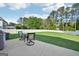 Landscaped backyard with green grass, patio and outdoor seating at 612 Longer Dr, Peachtree City, GA 30269