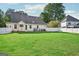 Spacious backyard with lush lawn, white fence, and home exterior view at 612 Longer Dr, Peachtree City, GA 30269
