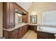 Elegant bathroom with custom vanity, granite countertop, soaking tub, and luxurious fixtures at 612 Longer Dr, Peachtree City, GA 30269