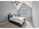 Bedroom with gray walls features vaulted ceilings and a large arched window for natural light at 612 Longer Dr, Peachtree City, GA 30269