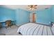 Bright blue bedroom features a woven desk chair and a plush striped bedspread at 612 Longer Dr, Peachtree City, GA 30269