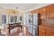 Inviting dining area with stainless steel refrigerator and view of a rustic wooden table at 612 Longer Dr, Peachtree City, GA 30269