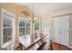 Bright dining area featuring a rustic wooden table, bench seating, and plenty of natural light at 612 Longer Dr, Peachtree City, GA 30269